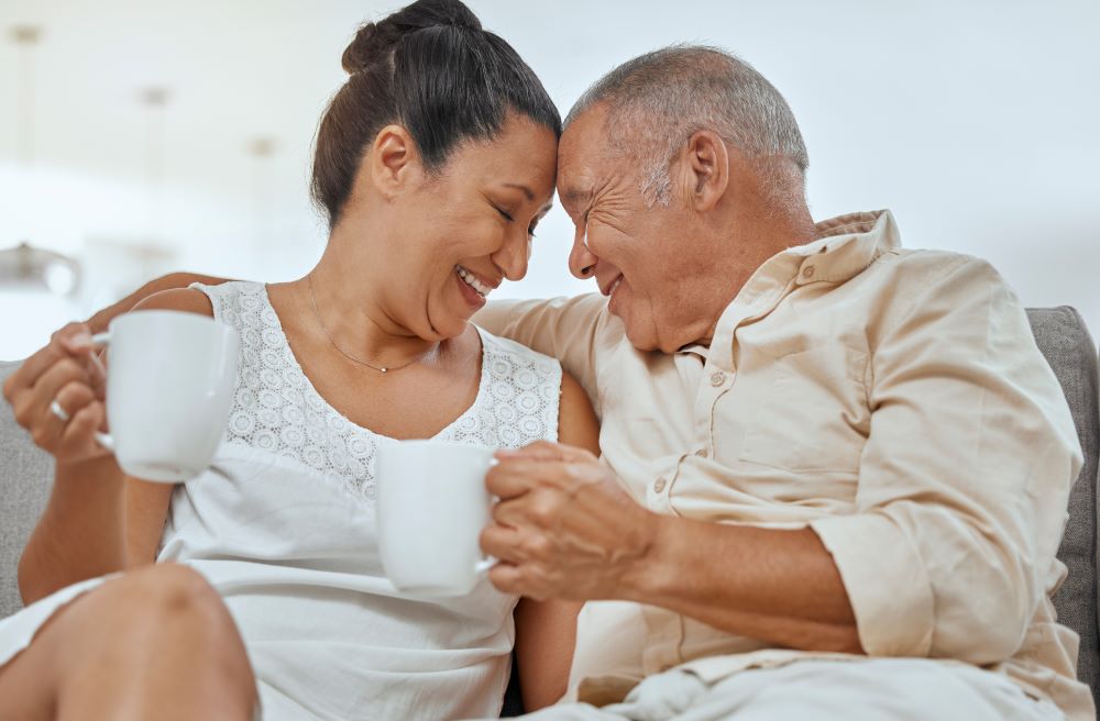 A senior couple having a coffee on a sofa