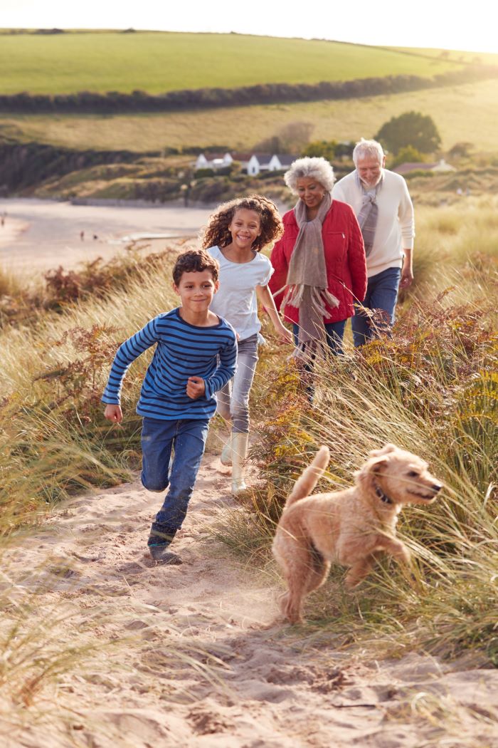 Grandparents with their grandchildren walking their dog